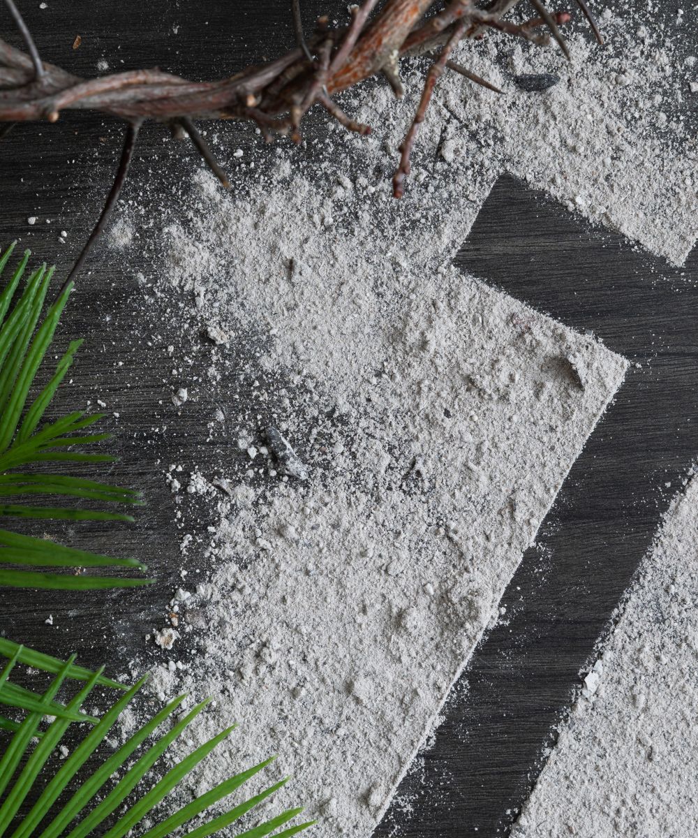 Lent background with cross of ashes, palm leaves and partial crown of thorns on dark wood